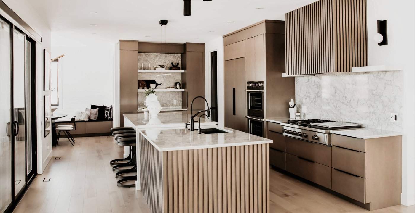Modern Scandinavian Kitchen With Reeded Island And Full Quartz Backsplash.